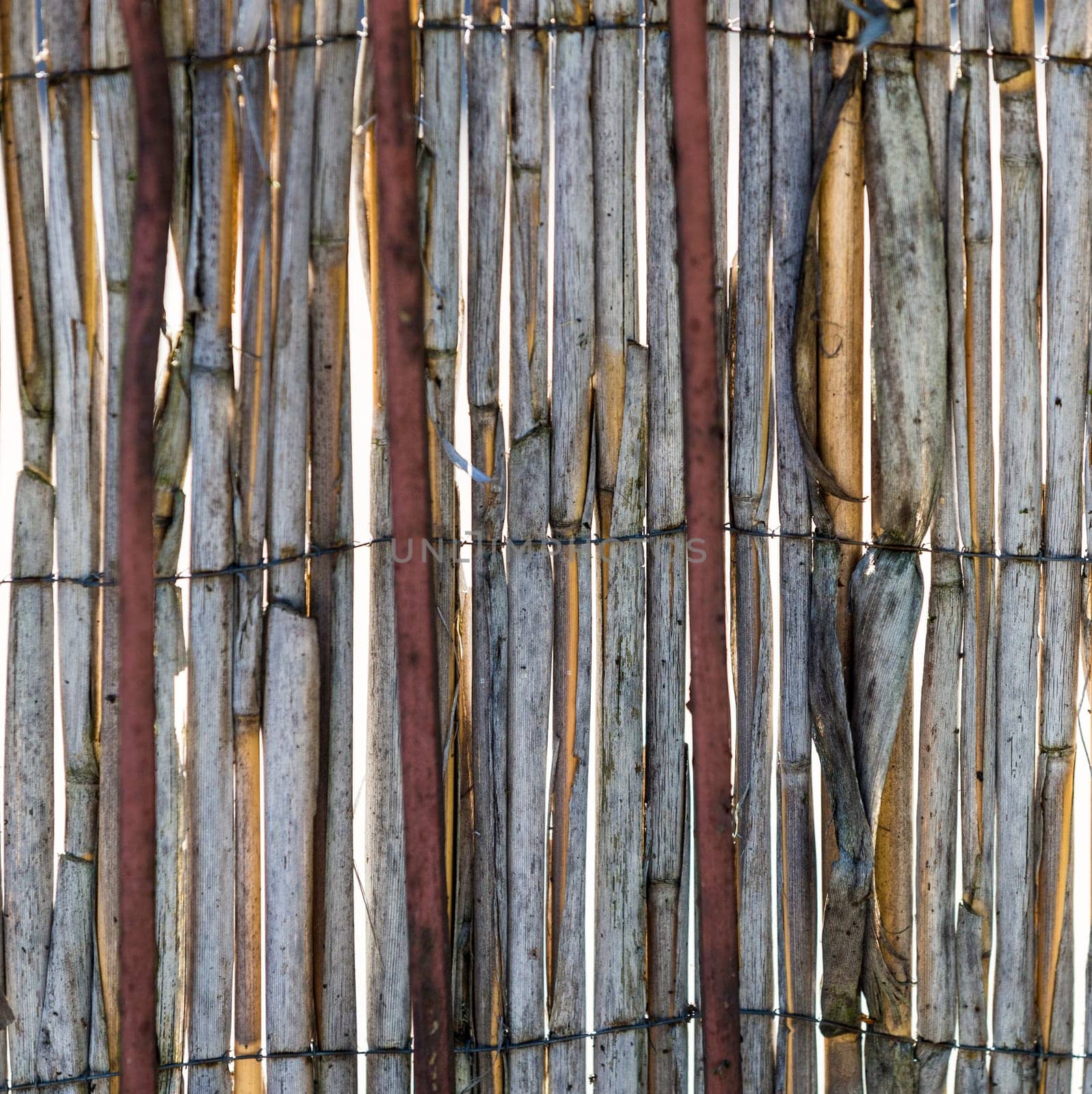 Abstract view of old rotten reeds fence