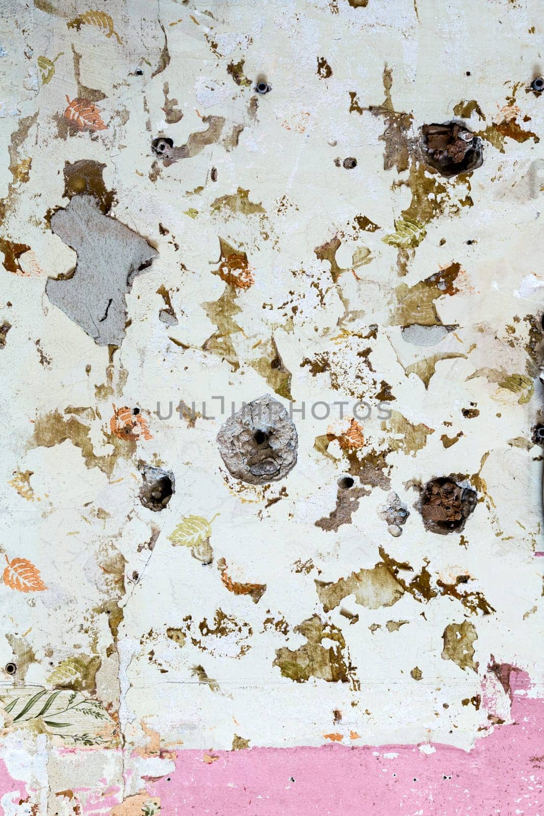 old grunge wall of an old house with remainings of color