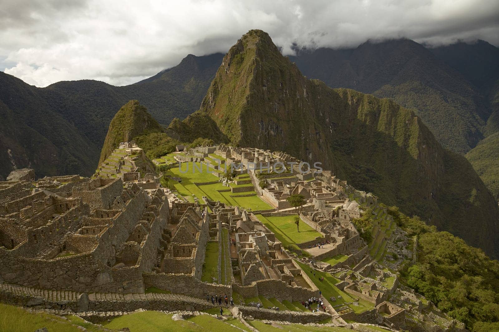 MACHU PICCHU, CUSCO, PERU - NOVEMBER 25, 2011: People Visiting Lost Incan City of Machu Picchu near Cusco in Peru. Peruvian Historical Sanctuary and UNESCO World Heritage Site.
