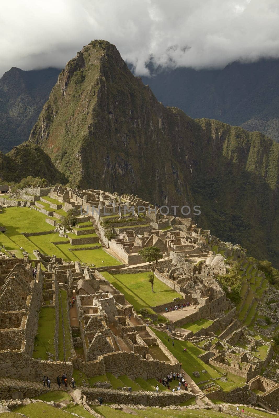 MACHU PICCHU, CUSCO, PERU - NOVEMBER 25, 2011: People Visiting Lost Incan City of Machu Picchu near Cusco in Peru. Peruvian Historical Sanctuary and UNESCO World Heritage Site.