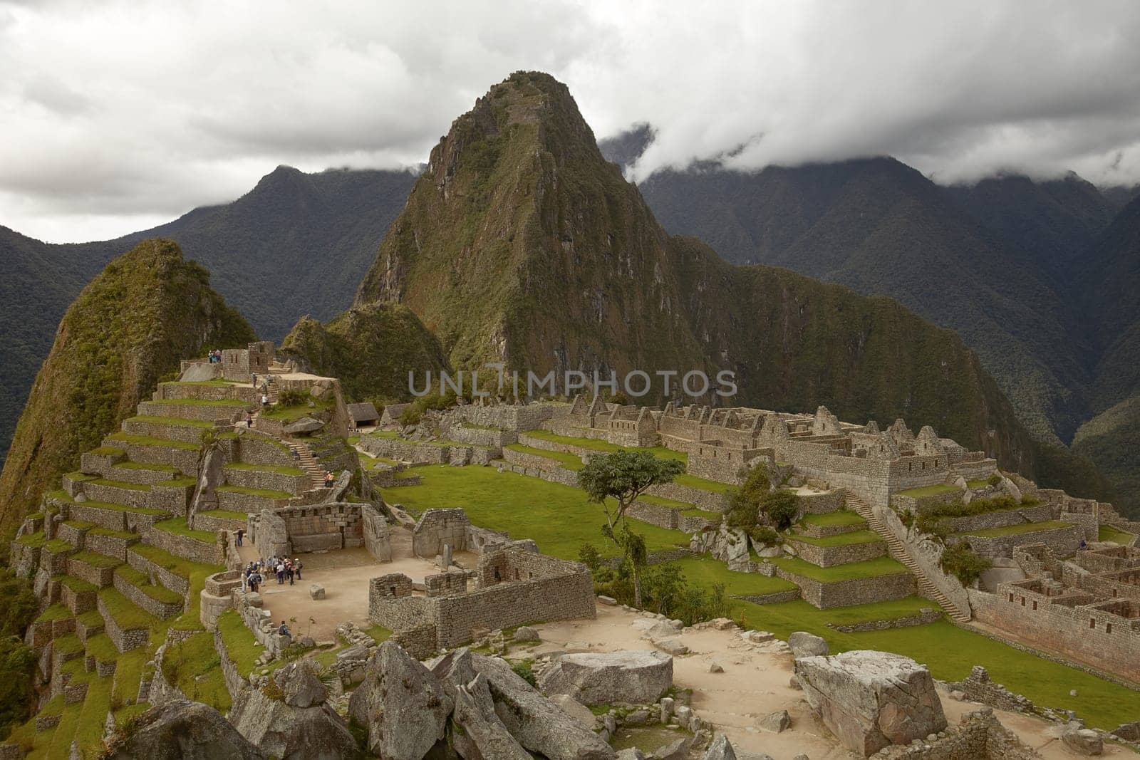 MACHU PICCHU, CUSCO, PERU - NOVEMBER 25, 2011: People Visiting Lost Incan City of Machu Picchu near Cusco in Peru. Peruvian Historical Sanctuary and UNESCO World Heritage Site.