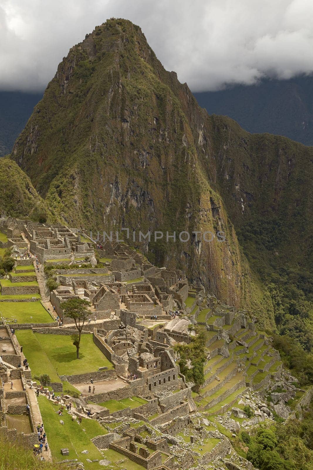 MACHU PICCHU, CUSCO, PERU - NOVEMBER 25, 2011: People Visiting Lost Incan City of Machu Picchu near Cusco in Peru. Peruvian Historical Sanctuary and UNESCO World Heritage Site.