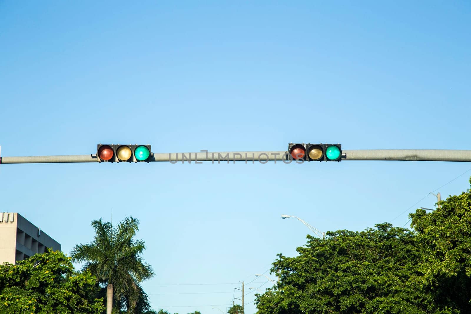 green  traffic lights under blue sky