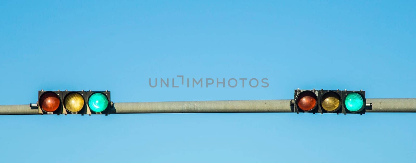 green  traffic lights under blue sky