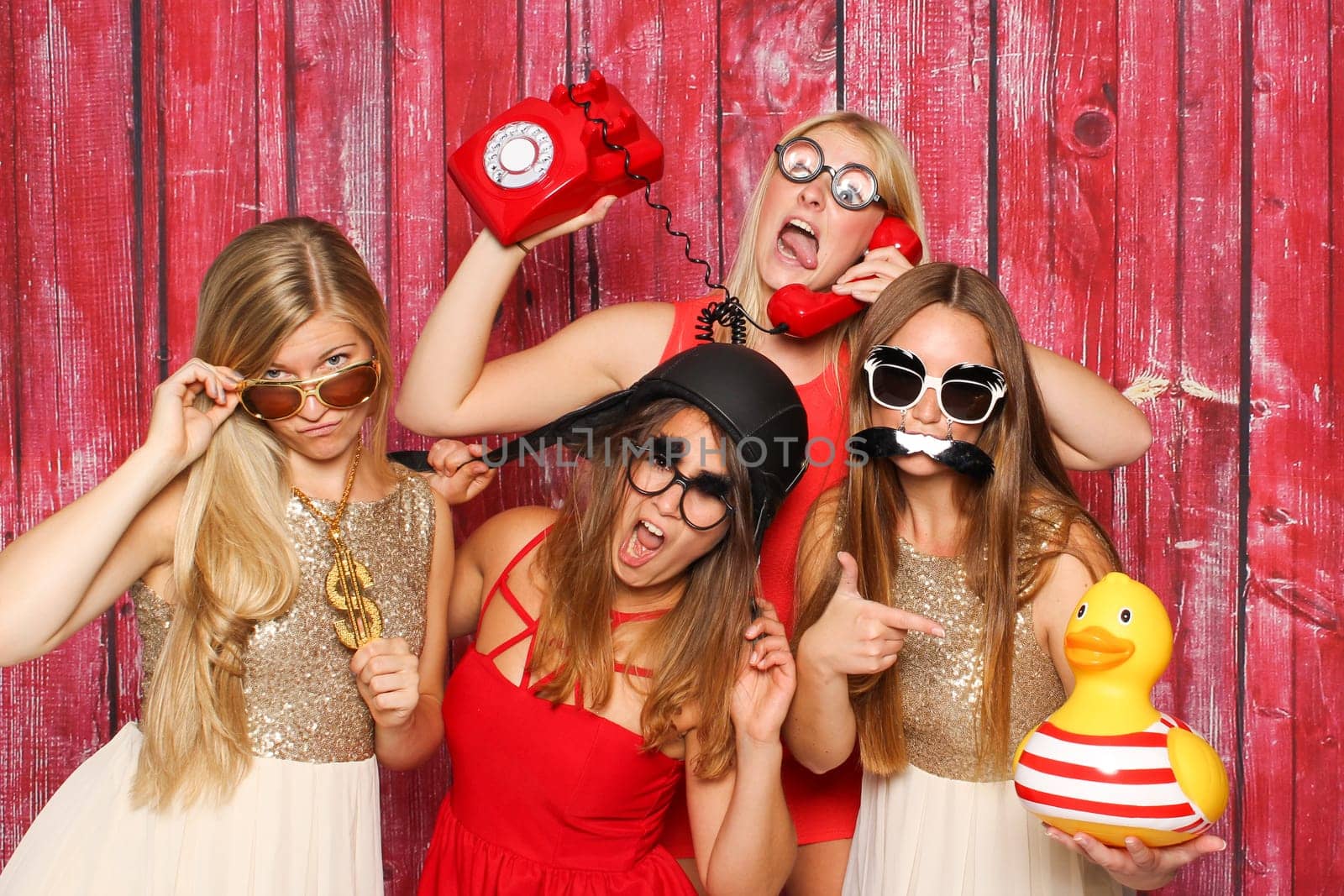 Young girls silly in front of photo box around