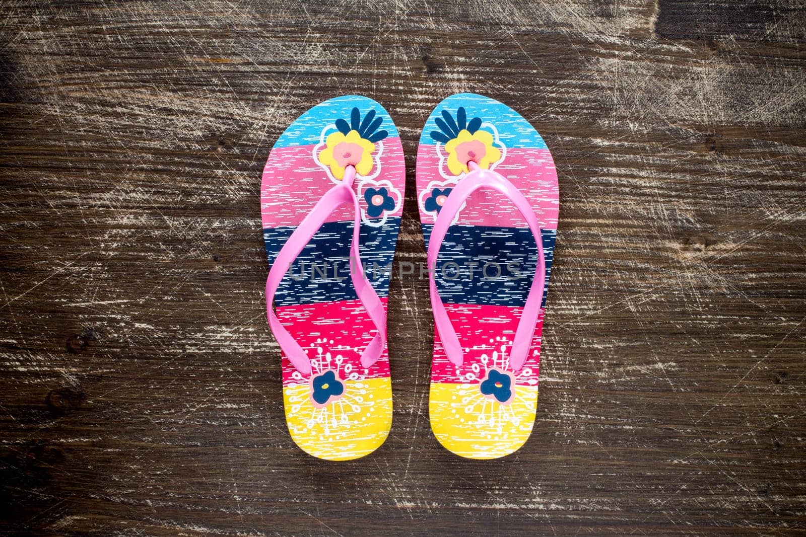 Flip flop sandals on old wooden floor. Top view .
