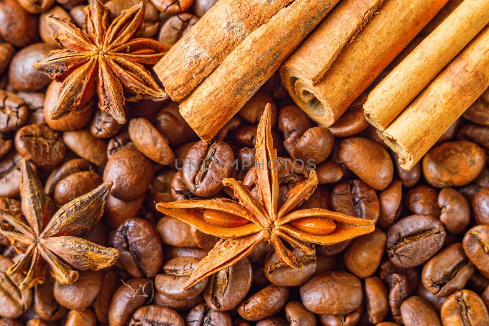 Close-up of coffee beans with star anise and cinnamon.
