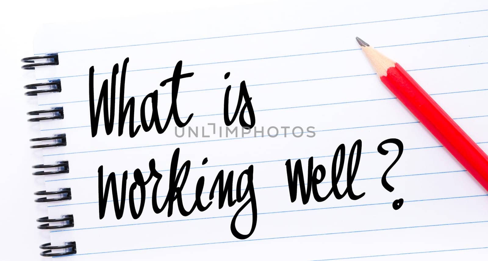 What Is Working Well ? written on notebook page with red pencil on the right