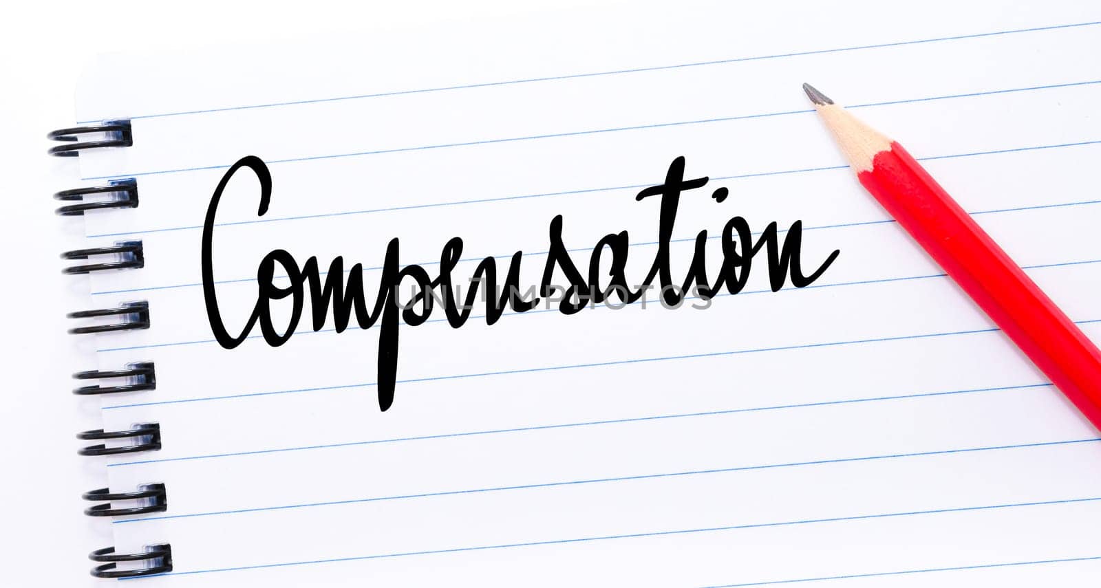 Compensation written on notebook page with red pencil on the right