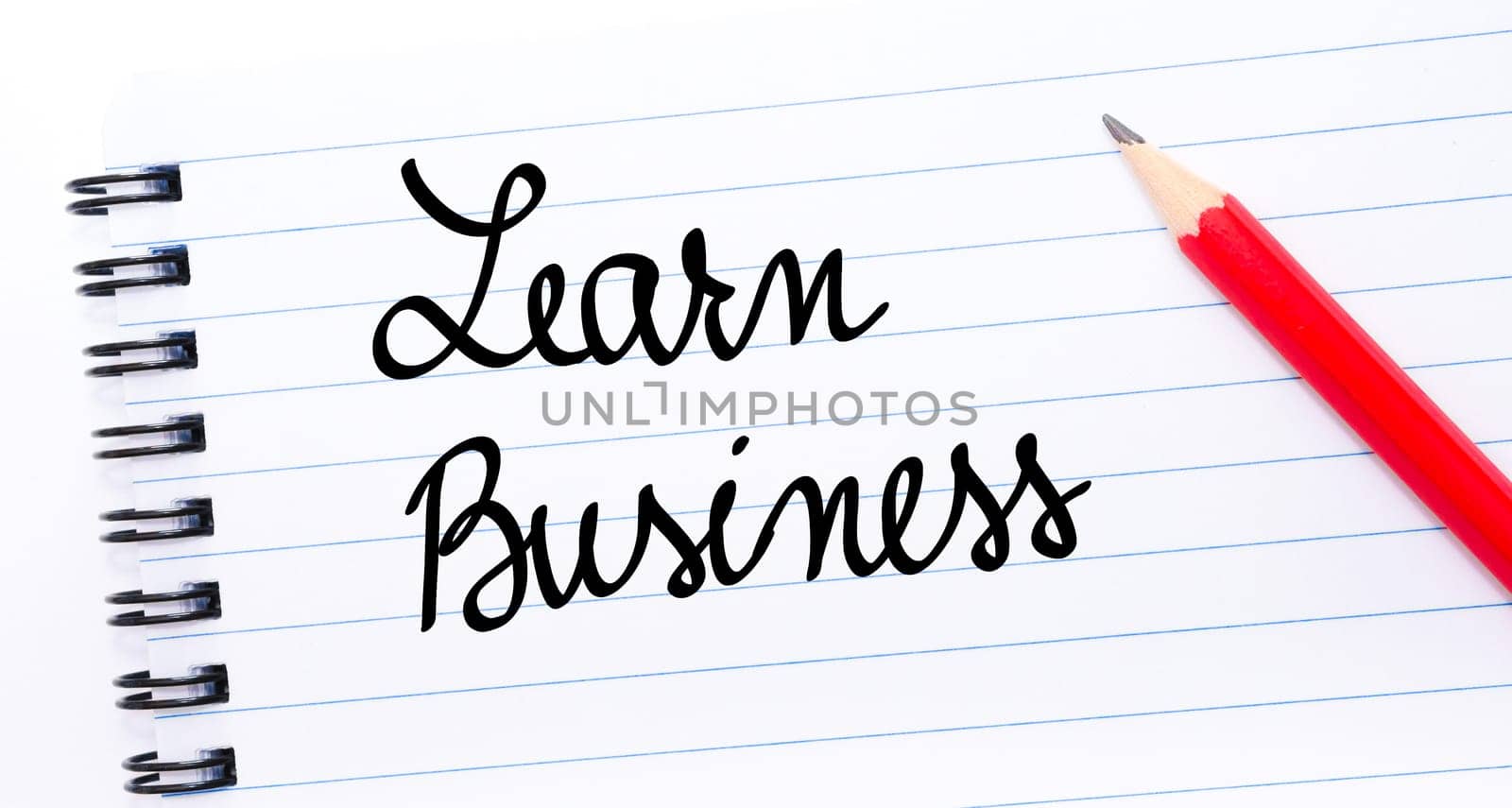 Learn Business written on notebook page with red pencil on the right