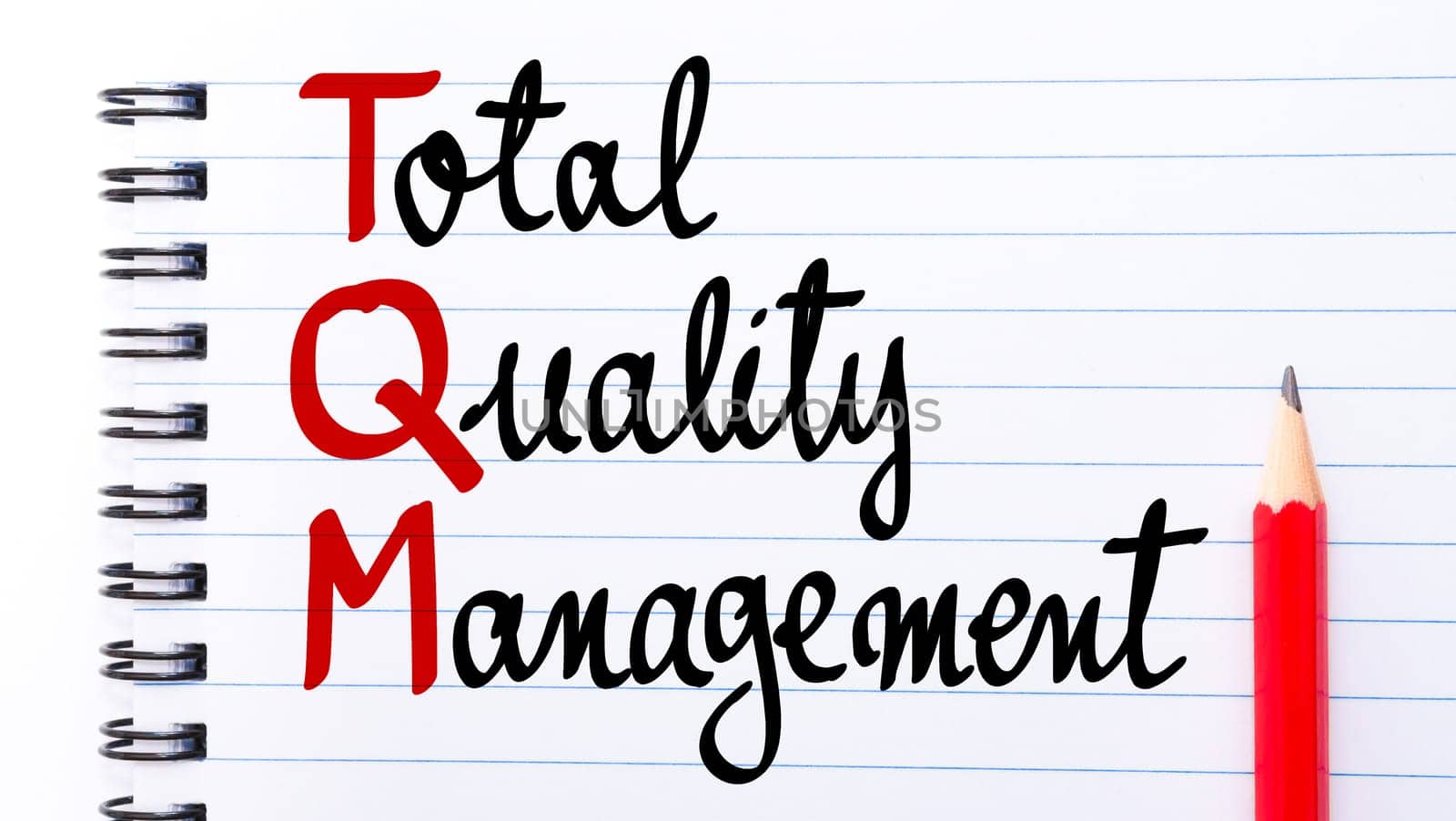 TQM Total Quality Management written on notebook page with red pencil on the right