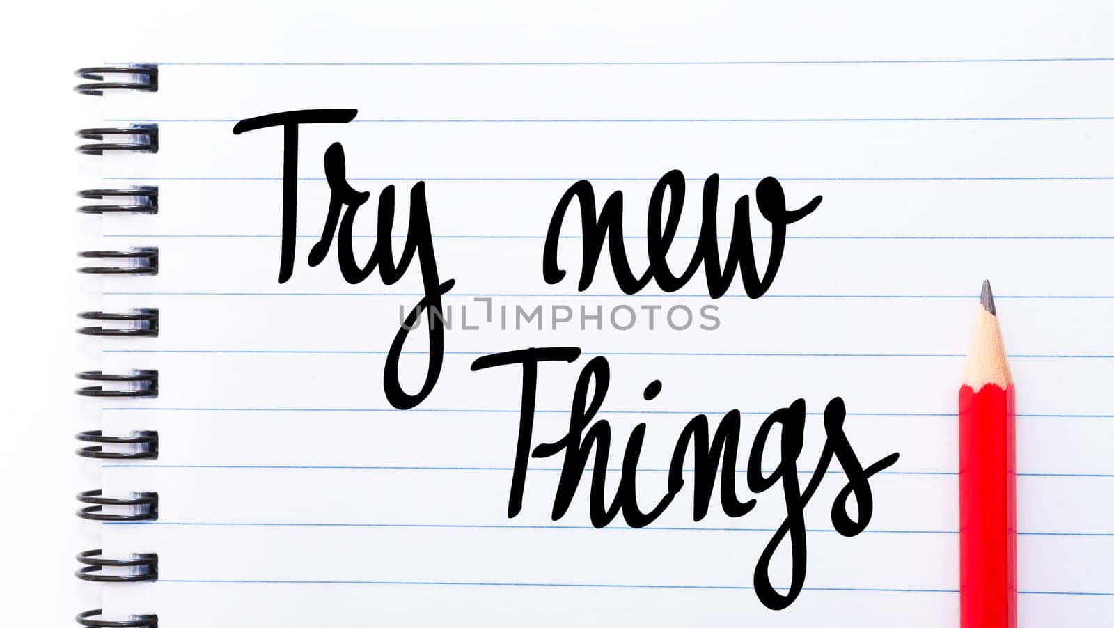 Try New Things written on notebook page with red pencil on the right
