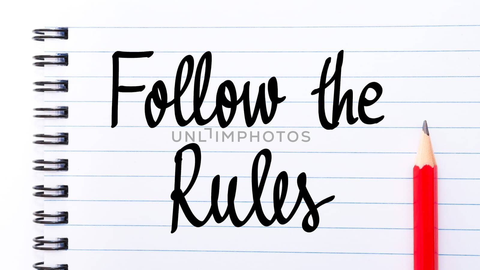 Follow The Rules written on notebook page with red pencil on the right