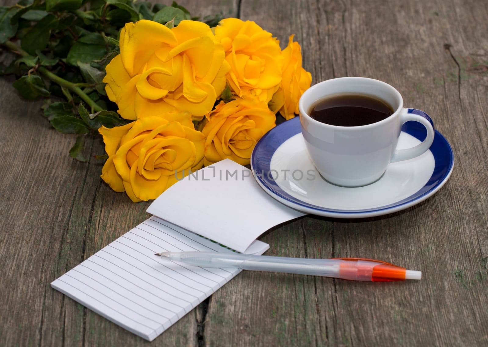 festive card, yellow roses, notebook and coffee, still life on a subject flowers and drinks
