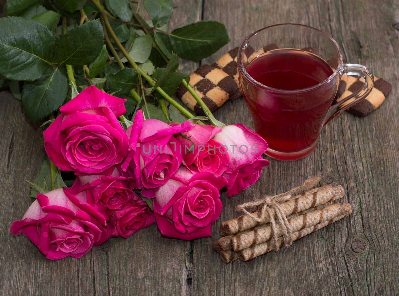 still life bouquet of roses, circle of red drink and two groups of cookies, subject beautiful flowers and drinks, greeting card