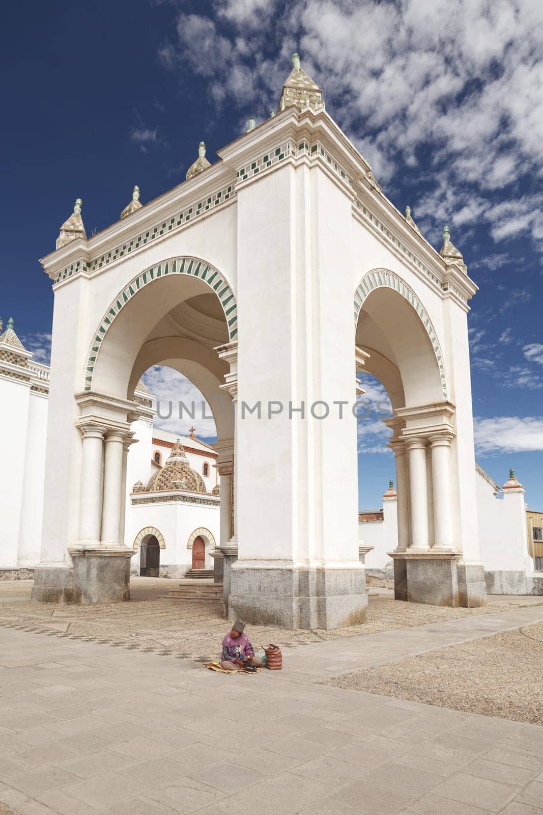 COPACABANA, BOLIVIA - JULY 28 2012: Homeless Old Man Sitting in Front of Church of Nuestra Senora de Copacabana, Lake Titicaca, Bolivia