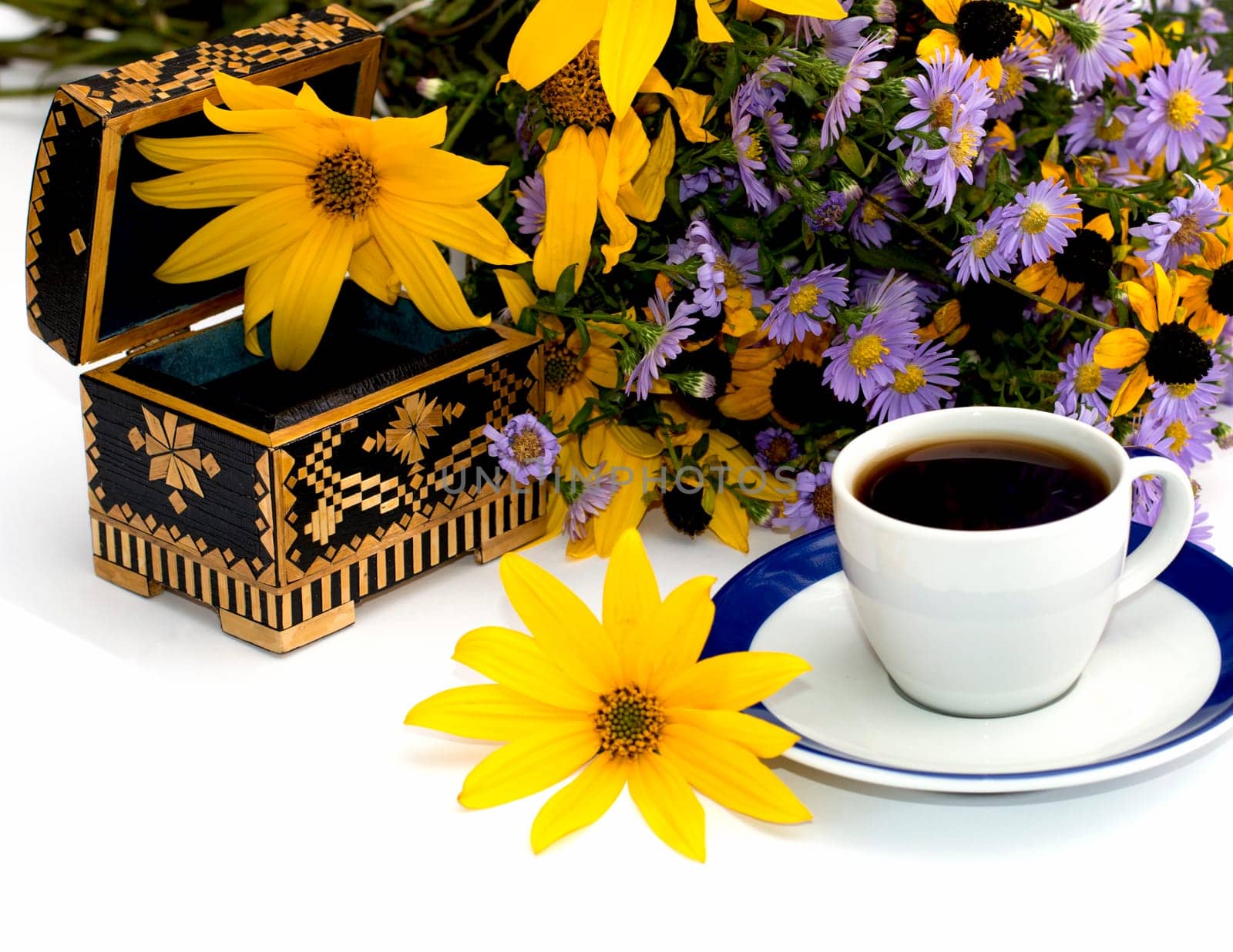 the open casket decorated yellow with flowers and coffee, isolate, still life, subject fall, drinks and flowers