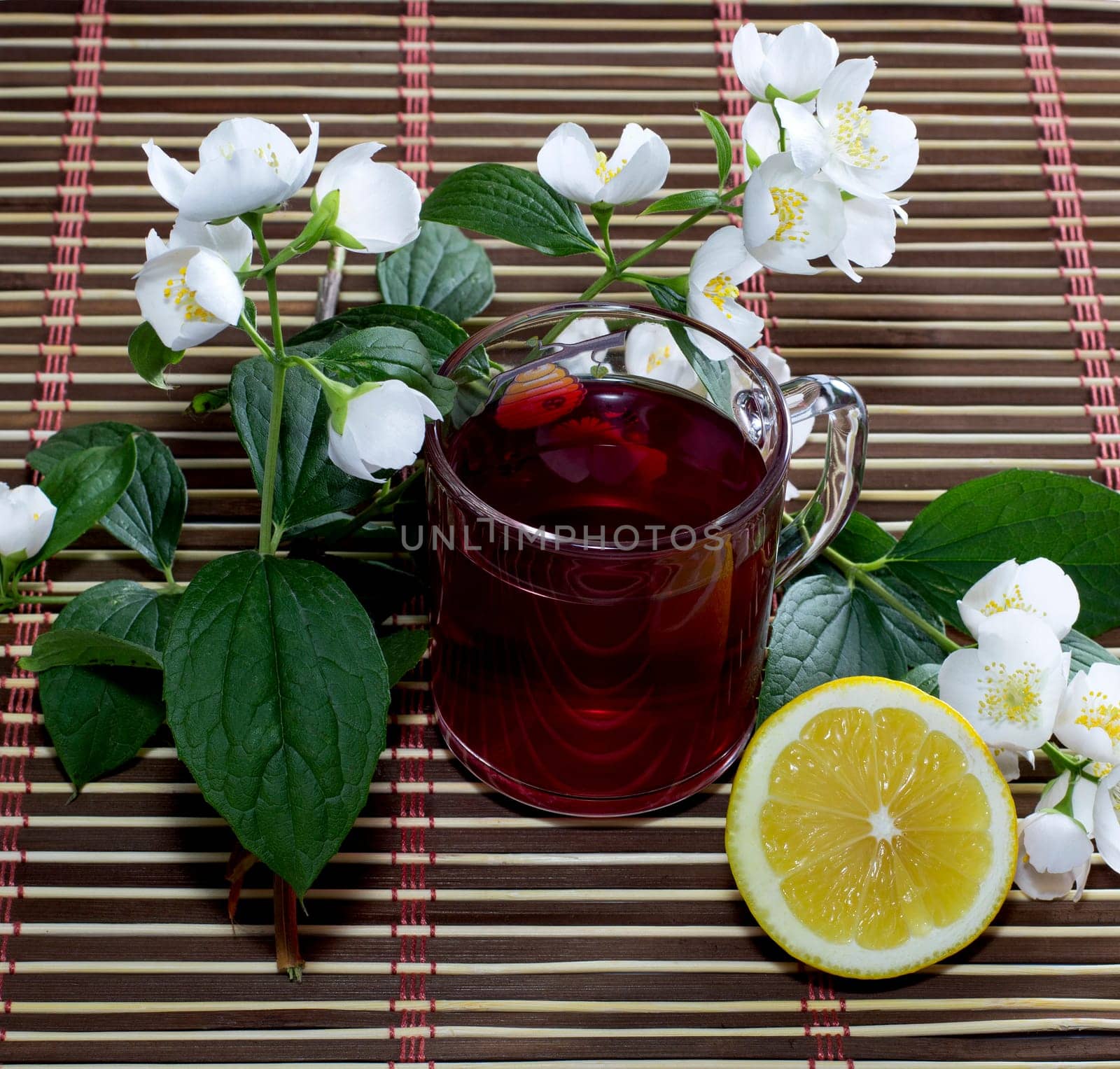 mug of red drink, the cut lemon and flower, still life, subject flowers and drinks