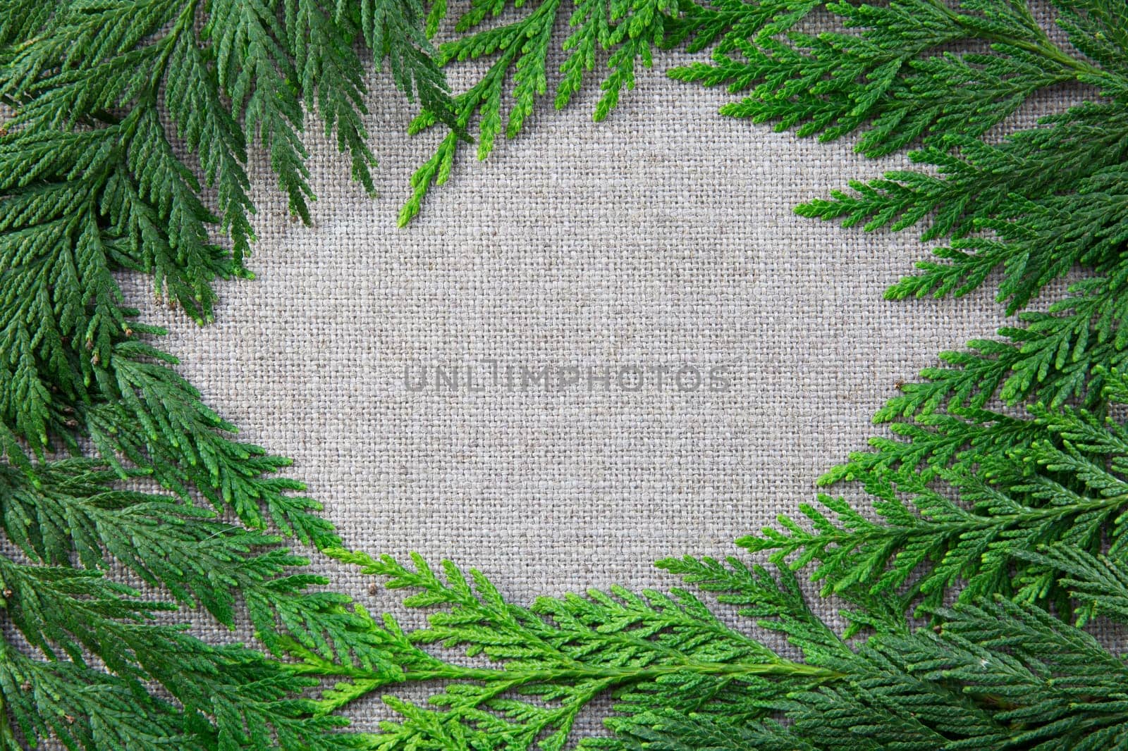 Greenery creating frame on linen background