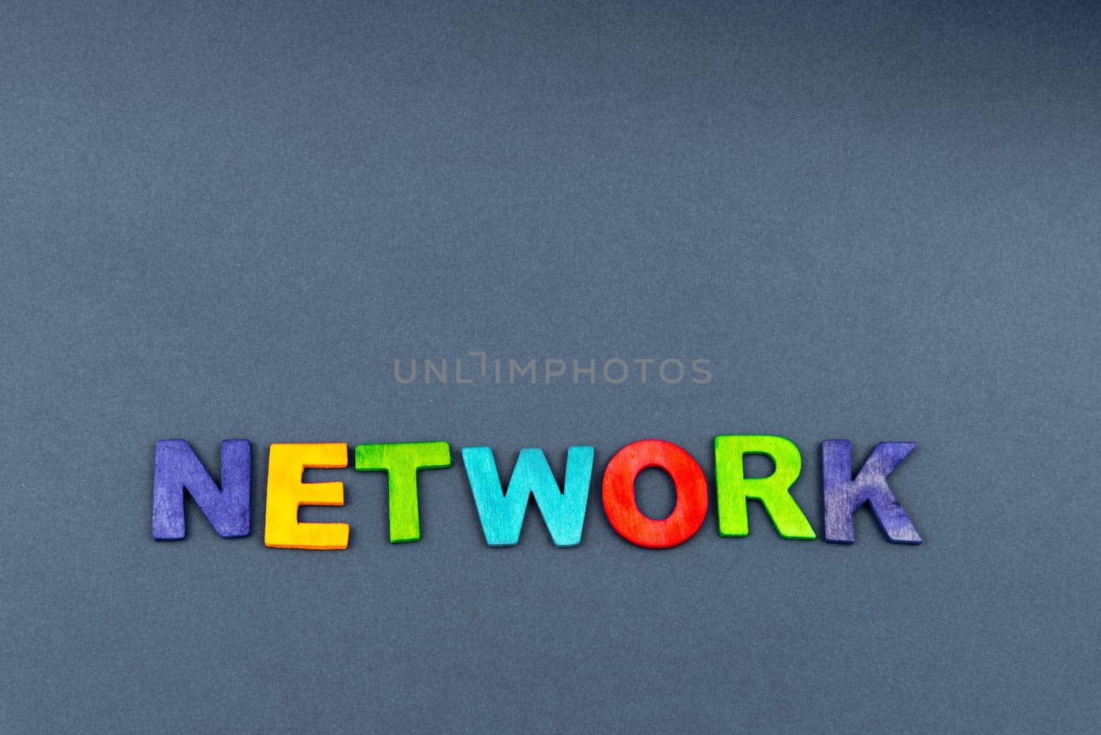 Word NETWORK created of wood letters on dark background, business concept, copy space available