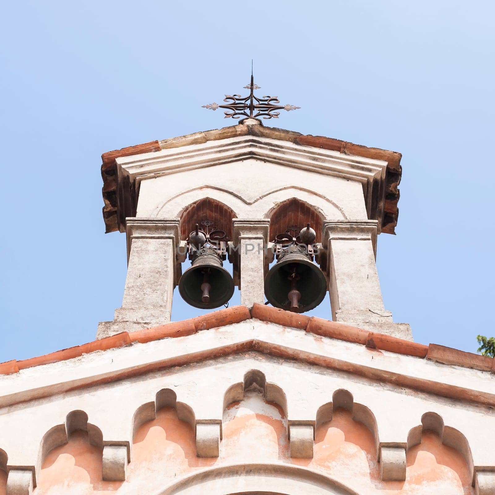 Small bell tower with a bell of a  church .