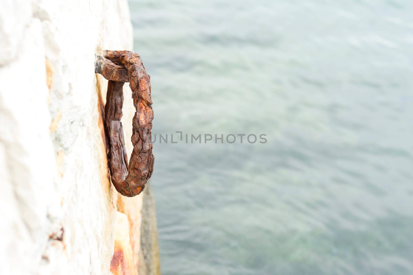 Old rustic ring for mooring boats on granite