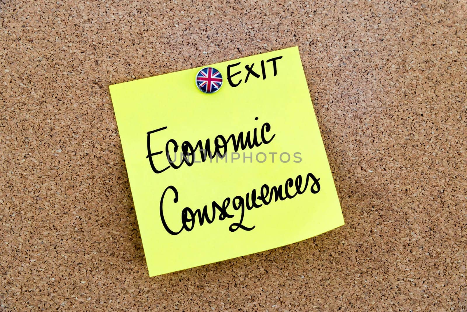 Yellow paper note pinned on cork board with Great Britain flag thumbtack, written text ECONOMIC CONSEQUENCES, United Kingdom exit from European Union