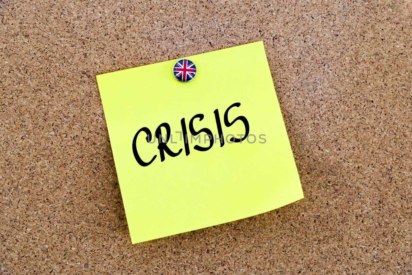 Yellow paper note pinned on cork board with Great Britain flag thumbtack, written text CRISIS, United Kingdom exit from European Union concept