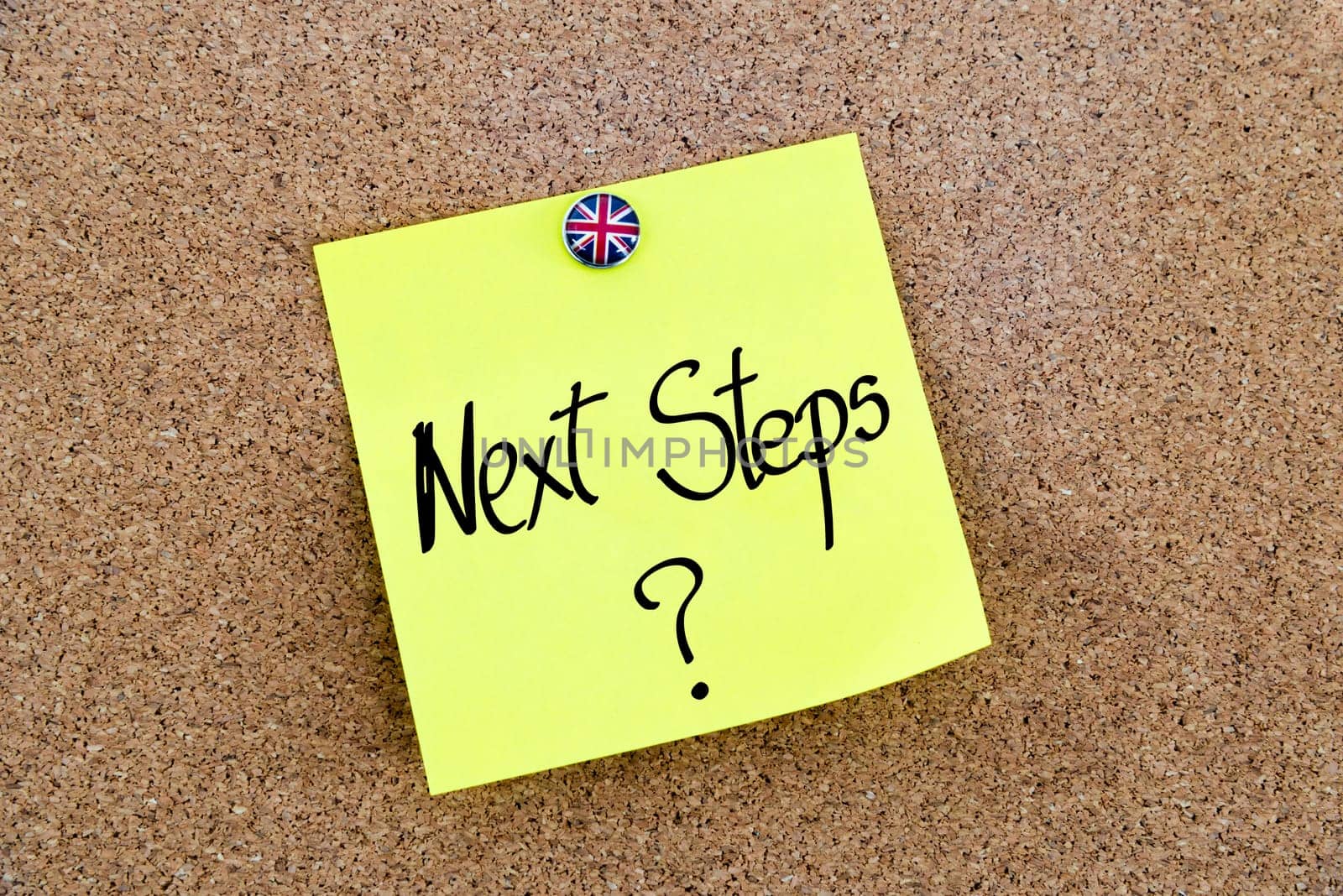 Yellow paper note pinned on cork board with Great Britain flag thumbtack, written text NEXT STEPS ?, United Kingdom exit from European Union