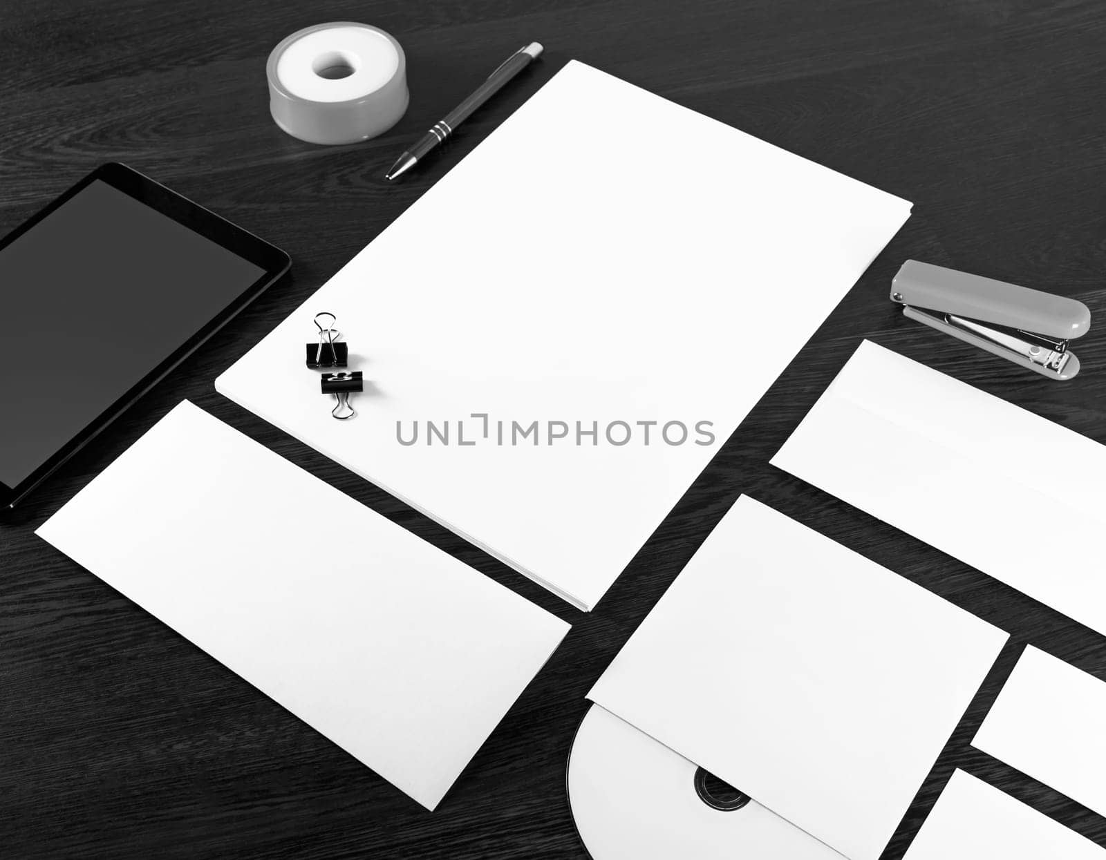 Blank stationery set. Corporate identity template on dark wooden background. Mockup for branding identity. For design presentations and portfolios.