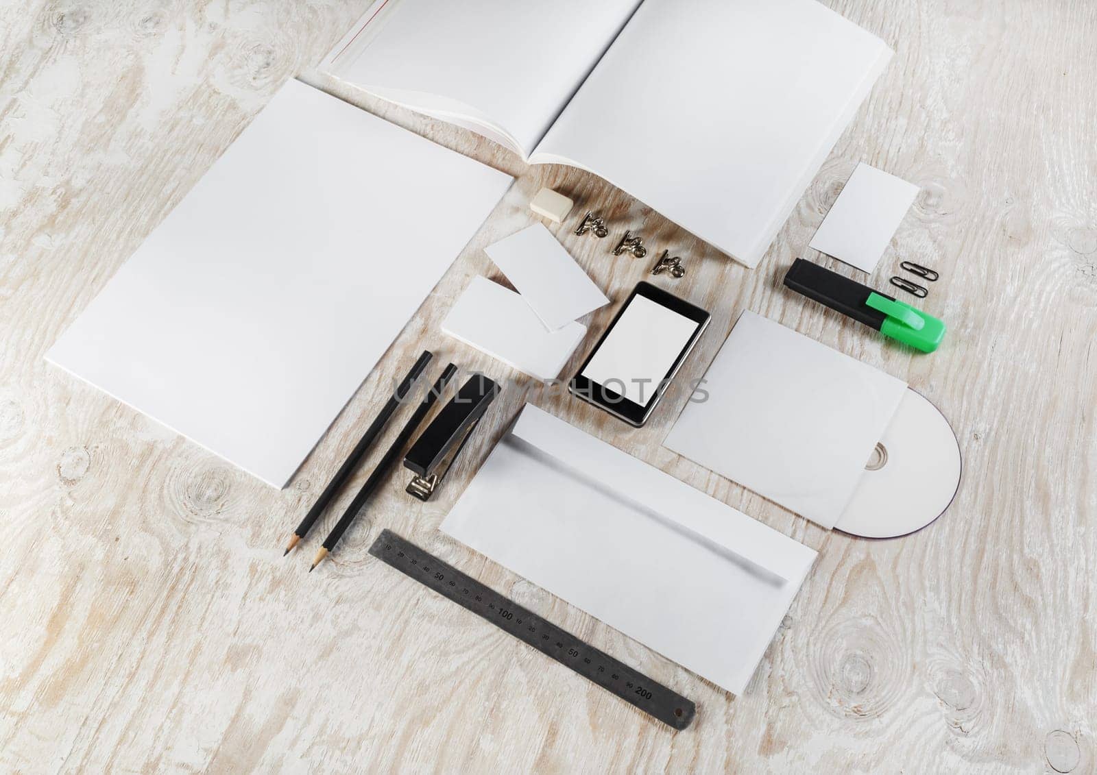Photo of blank corporate identity template on light wooden background. Mock-up for design presentations and portfolios.