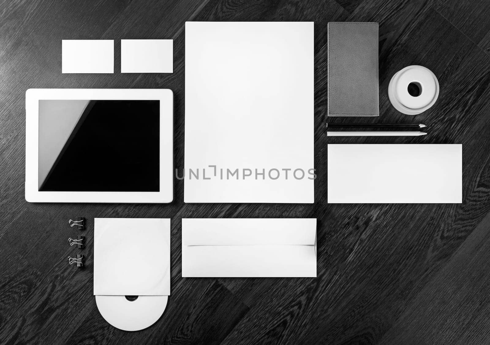 Photo of blank stationery and corporate identity template on dark wooden background. Mock-up for branding identity for designers. Top view.