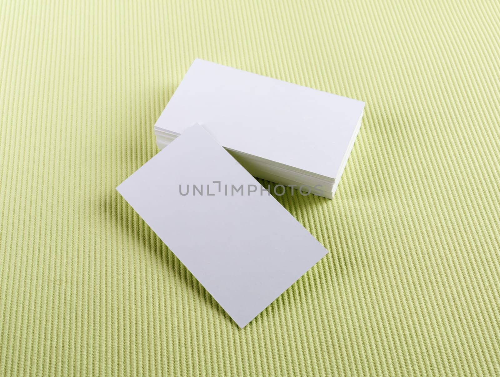 Blank business cards on green background. Template for ID.