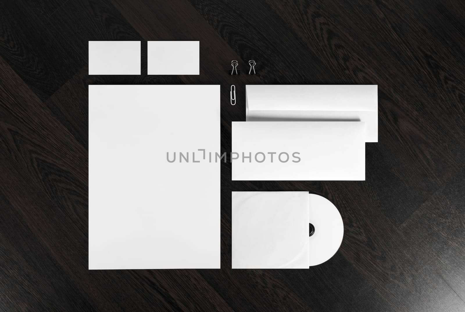 Blank stationery and corporate identity template on dark wooden background.  For design presentations and portfolios.
