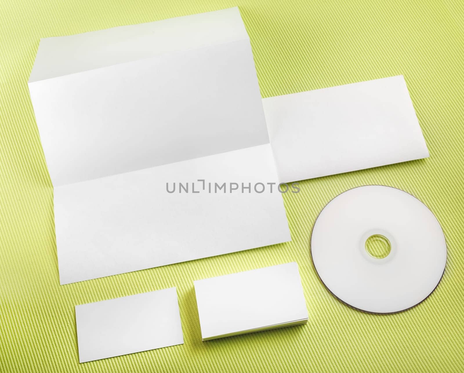 Blank stationery set on green background. Template for branding identity. Top view.