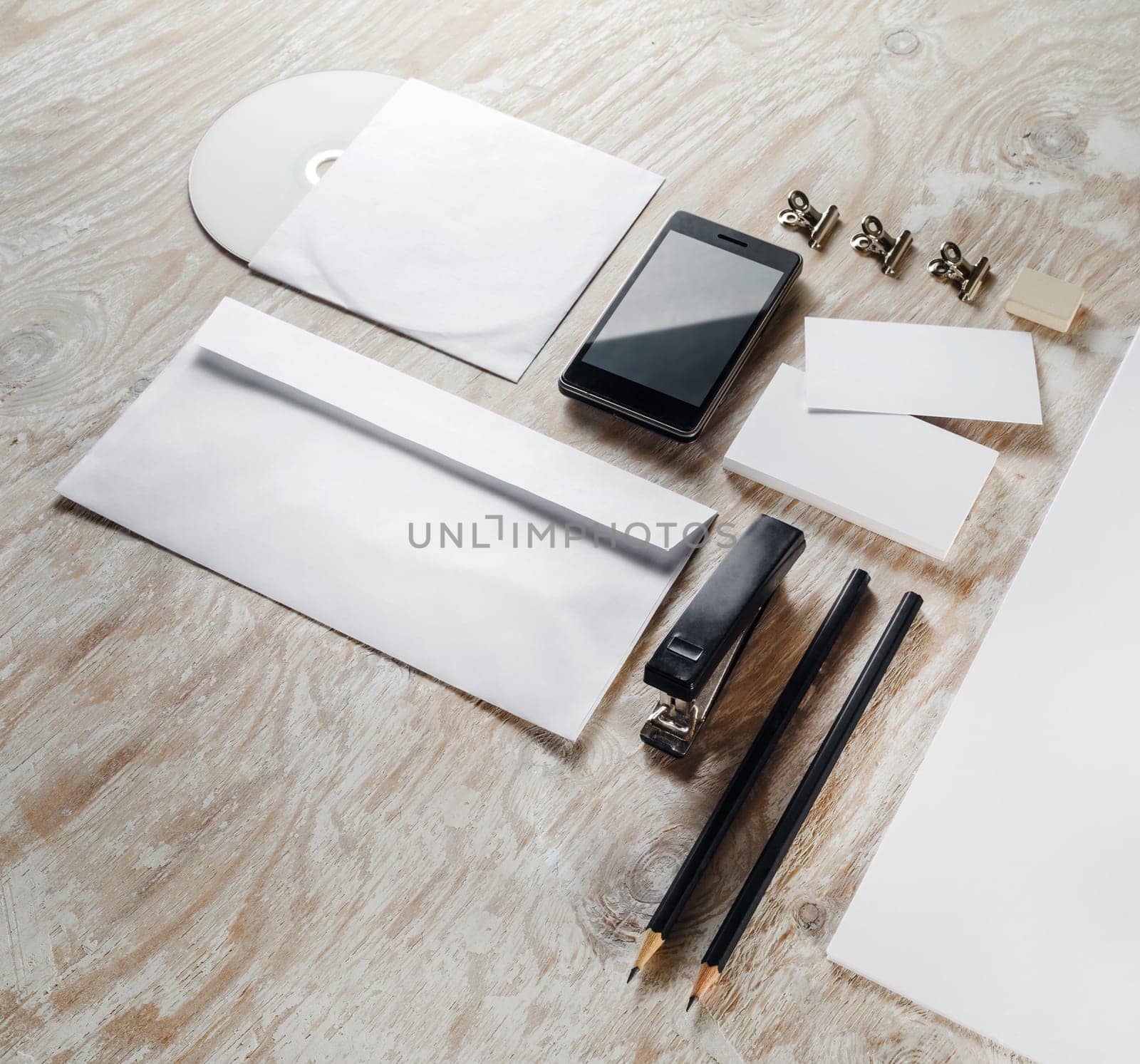 Photo of blank stationery set on light wooden background. Template for branding identity. Mock-up for graphic designers portfolios.