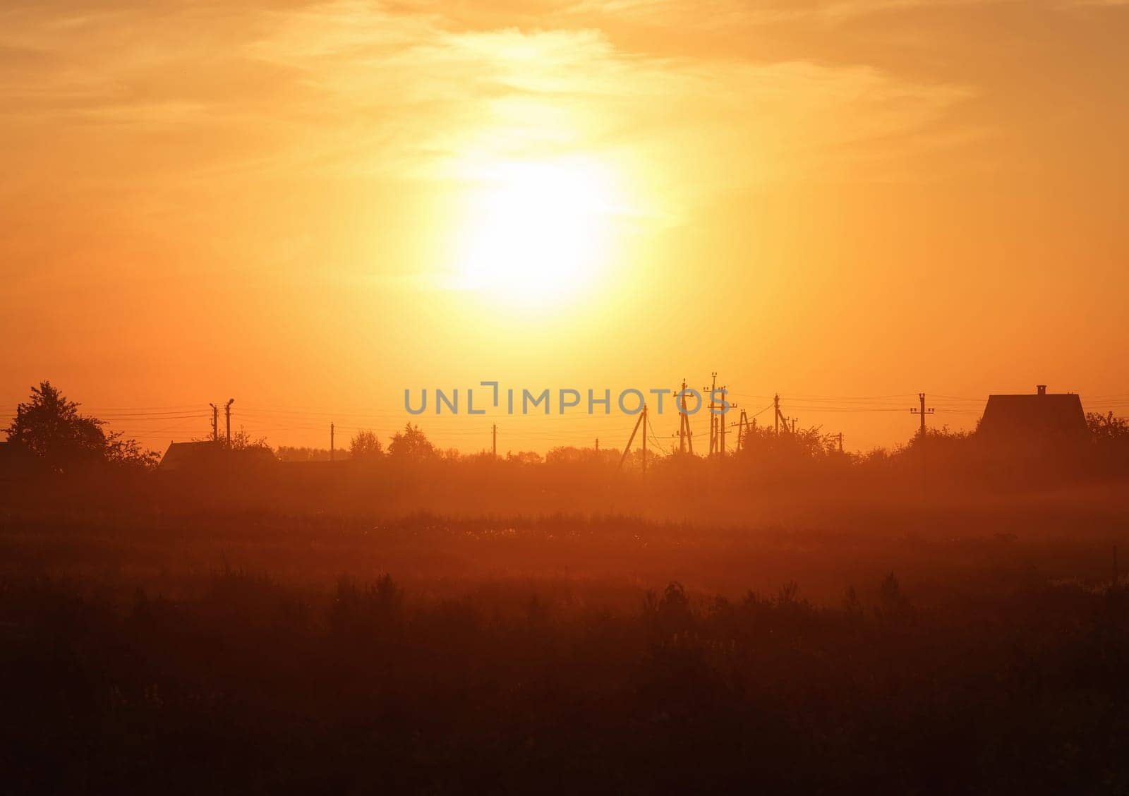 Orange sunset in the countryside. Scenic rural landscape. Toned image.