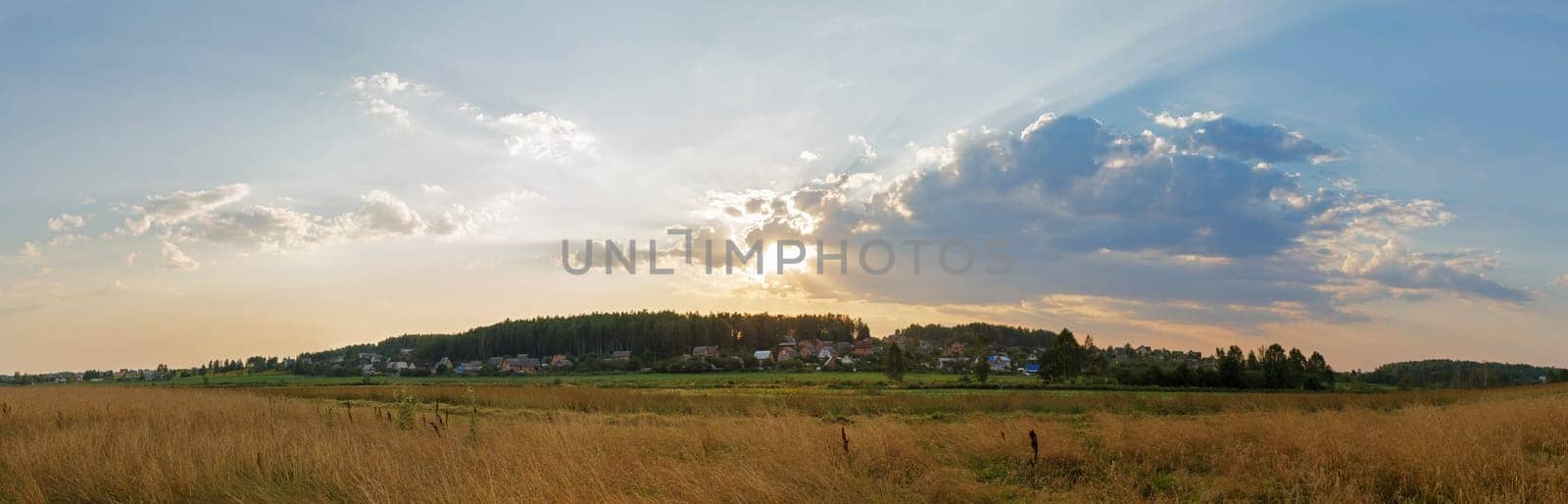 A picturesque sunset in the countryside. Panoramic rural landscape