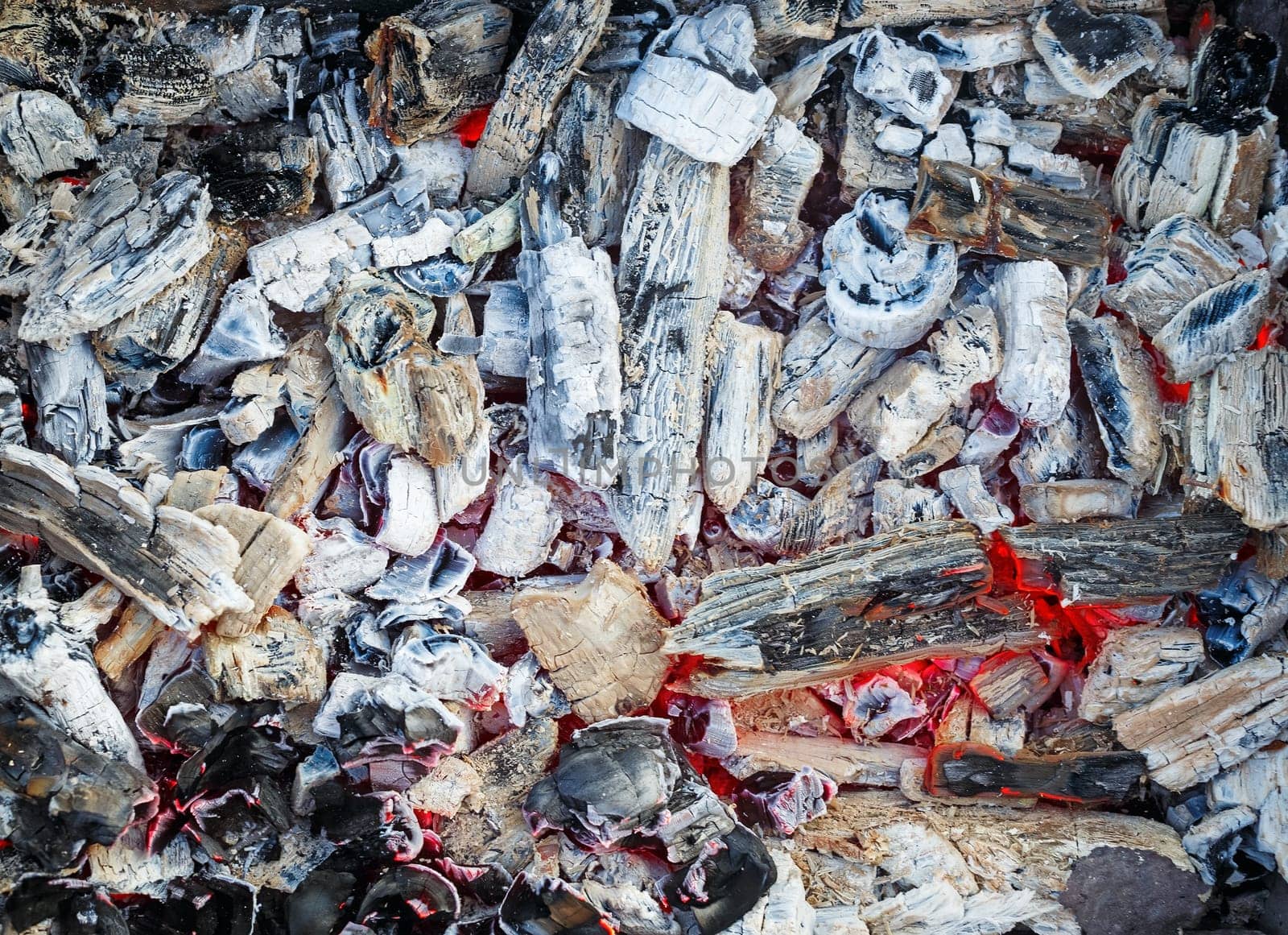 Embers texture closeup. Coals in the brazier. Embers and cinder after fire.