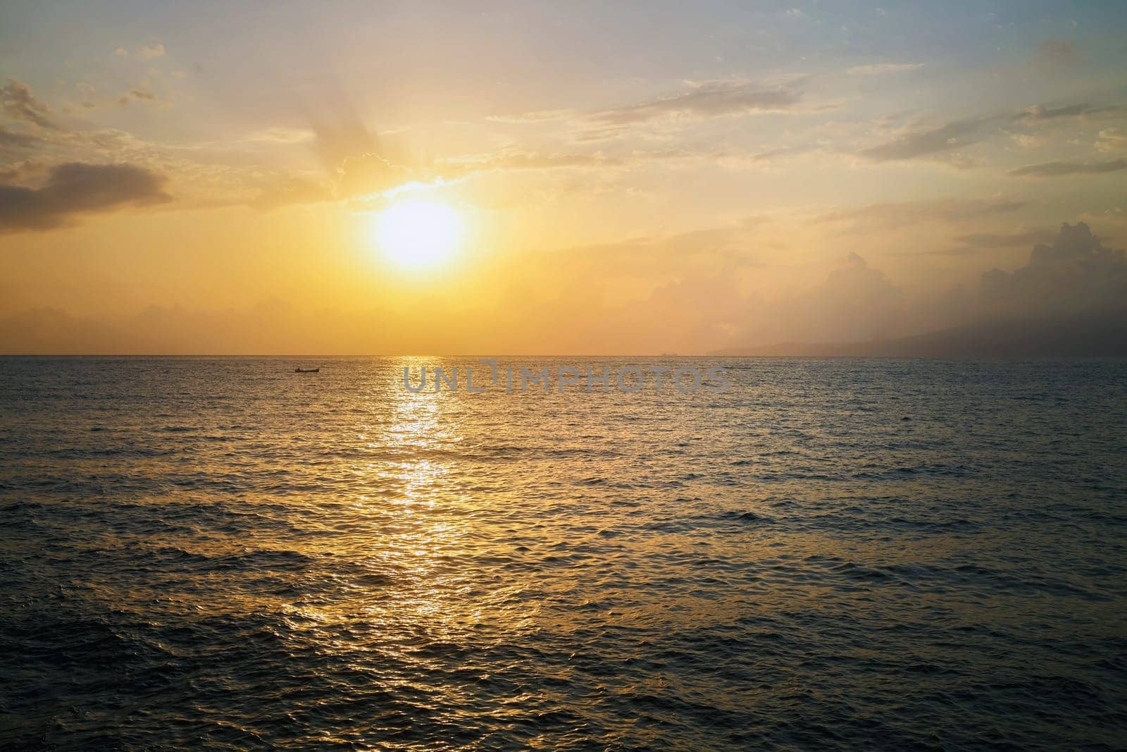 Beautiful seascape at sunrise. Reflection of the sun in the sea at dawn.