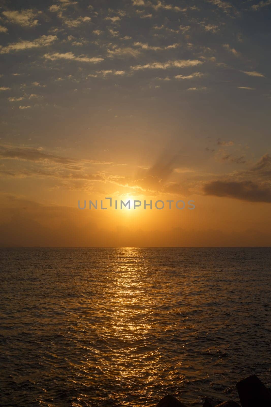 Bright sunrise over the sea. Vertical shot.