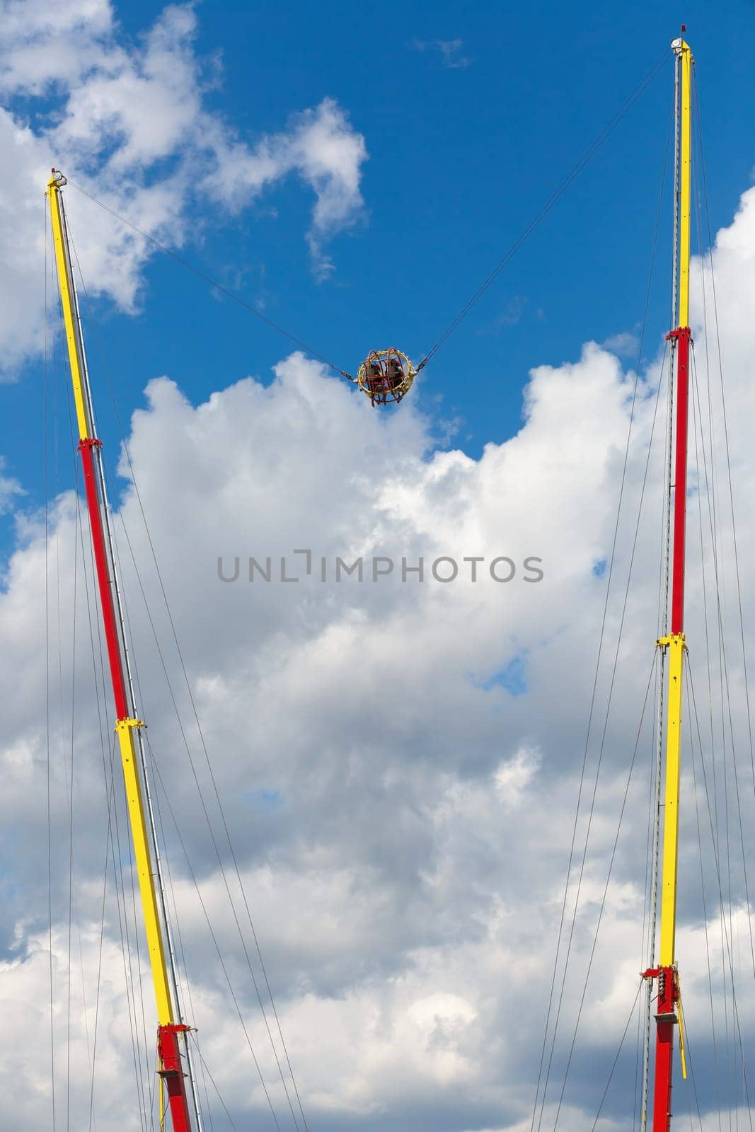 Extreme attraction - catapult in the park on against the sky. Vertical shot.