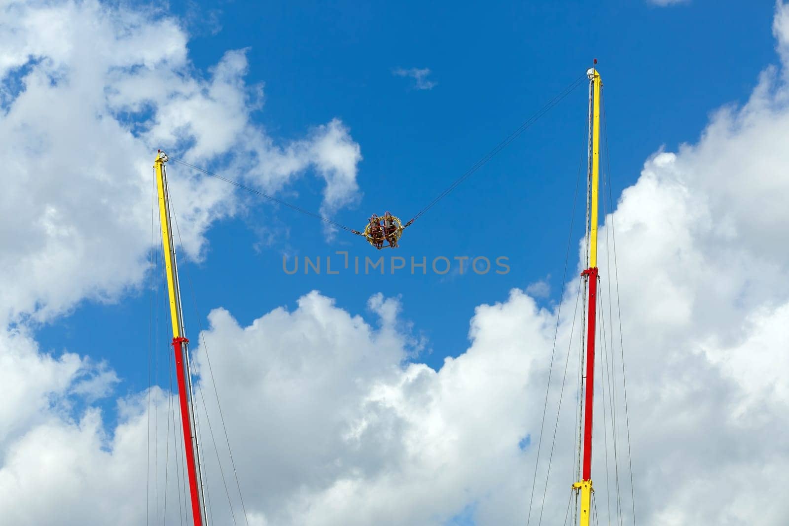 Extreme attraction - catapult in the park on a bright sunny day against the sky.