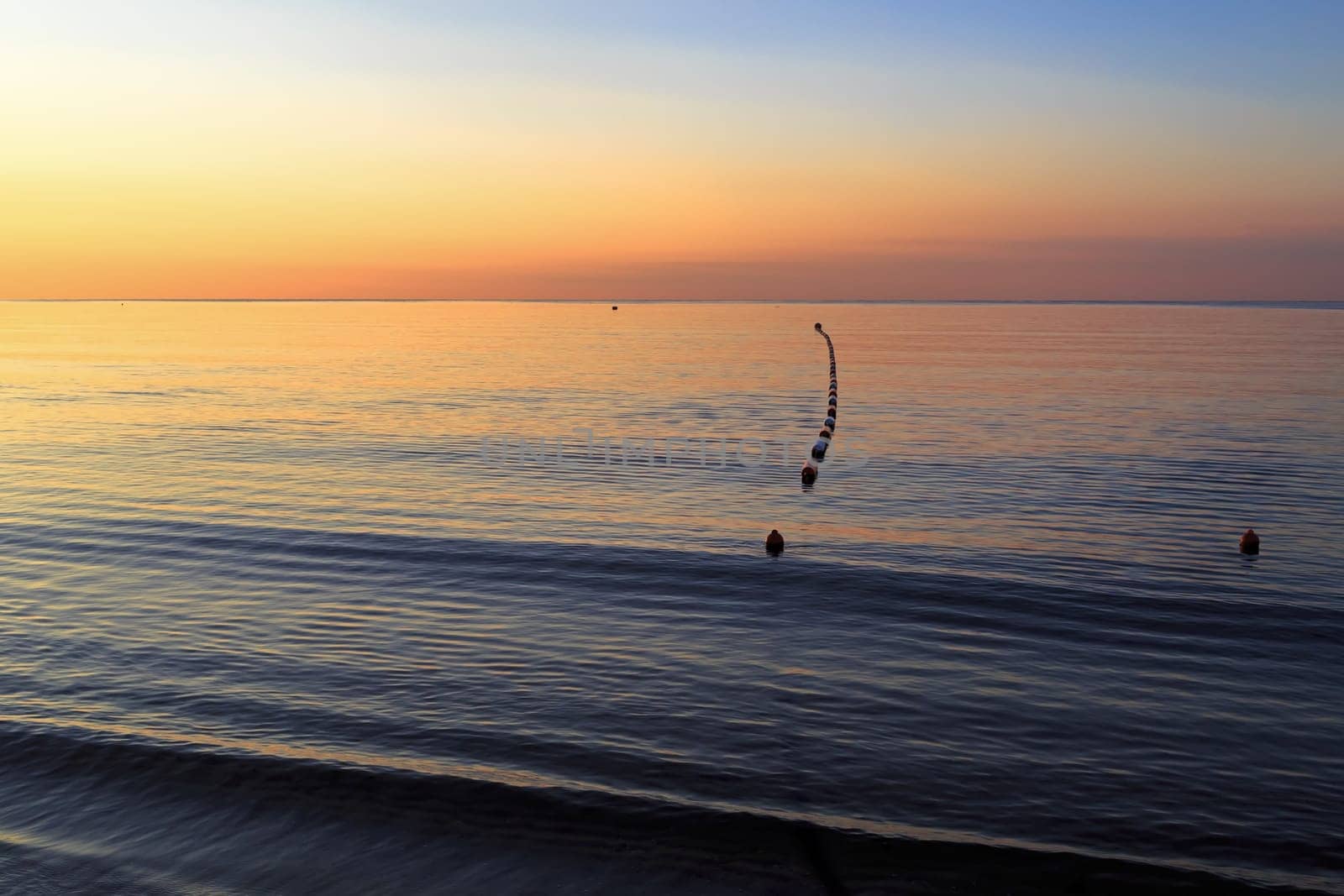 Bright colorful sunrise over the sea. Horizontal shot.