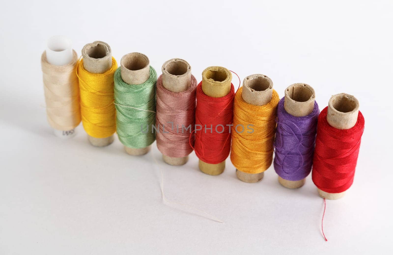 Several coils with color threads. Set of multicolored threads. Shallow depth of field.