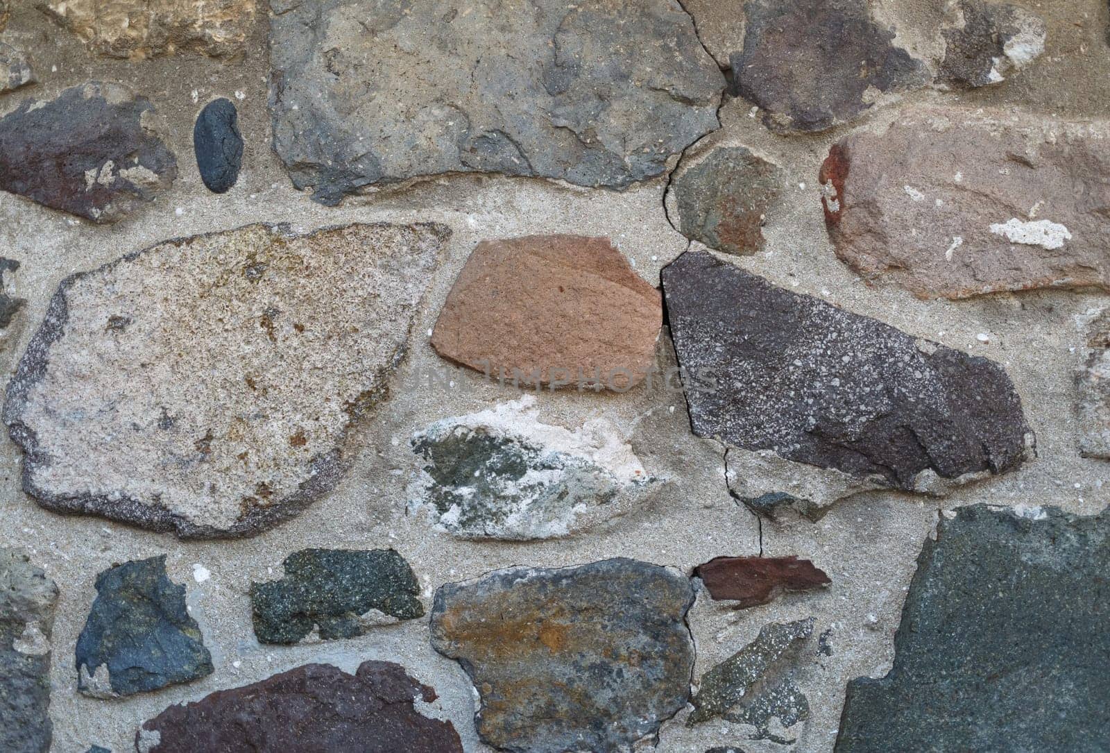 Old vintage stone wall of large rough stones.