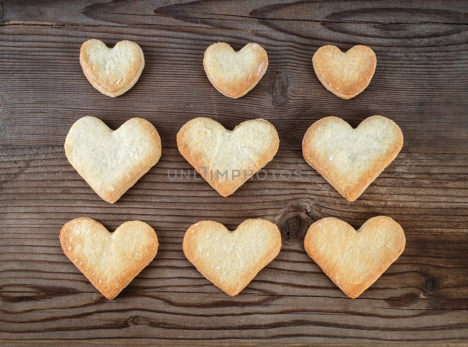 Heart shaped cookies on wooden background. Top view.