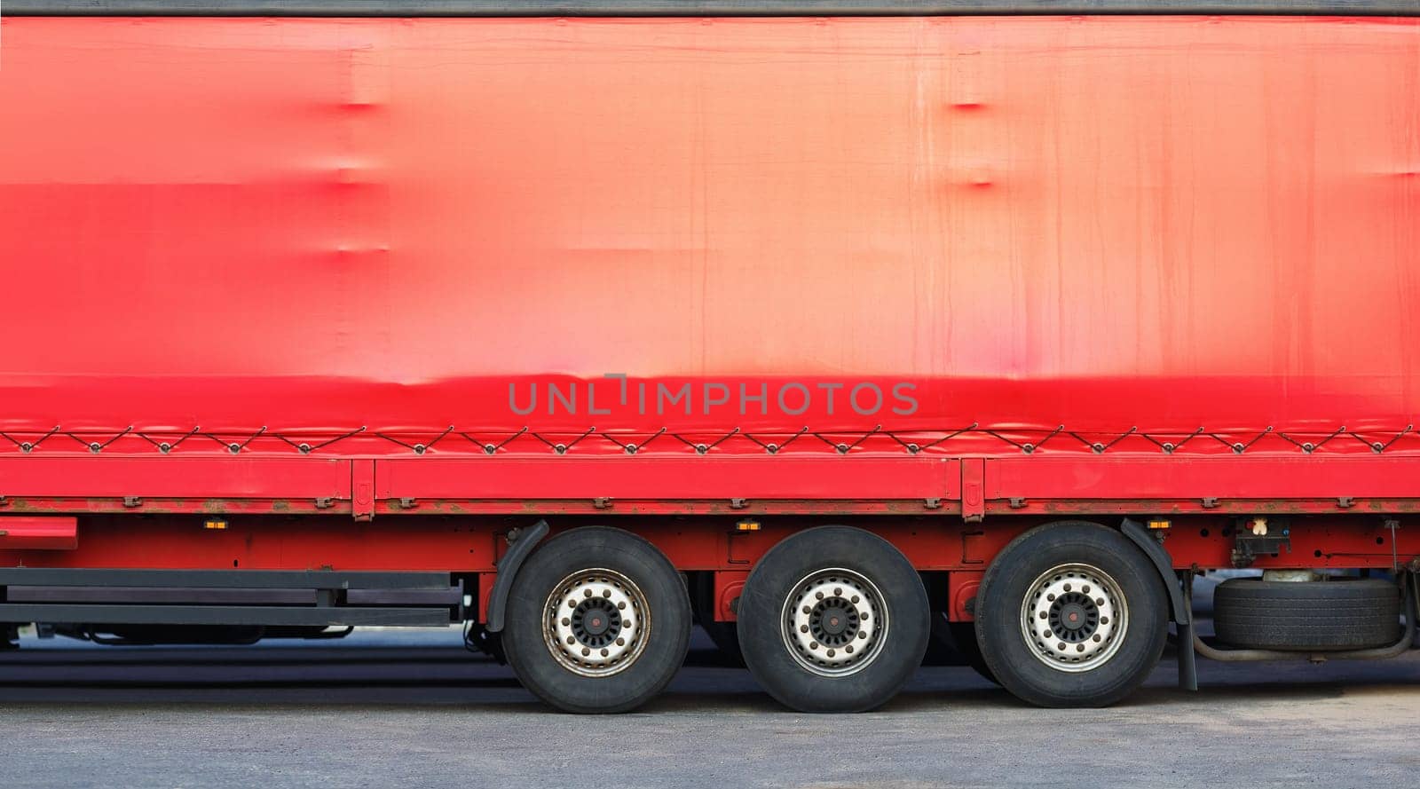 Close-up of the side of a big red truck. Space for text or image.