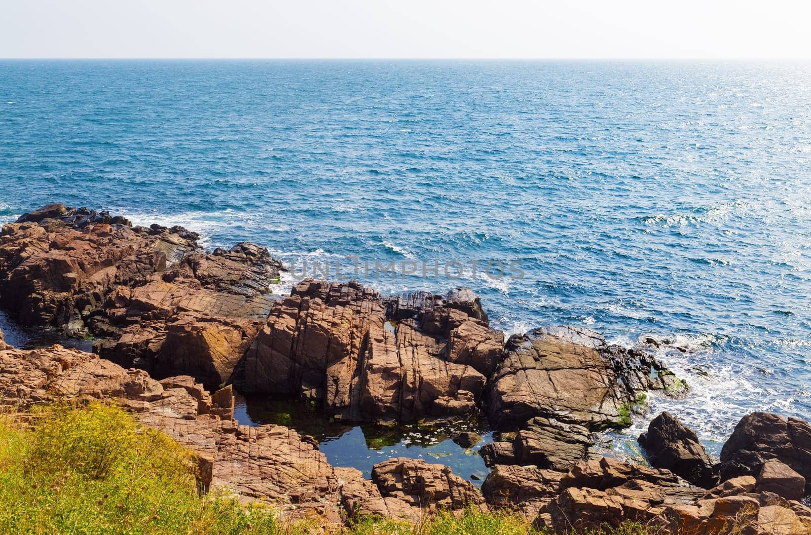 Beautiful picturesque seascape. Black Sea coast in bright sunny day. Rocky coast with large stone and.blue sea water.