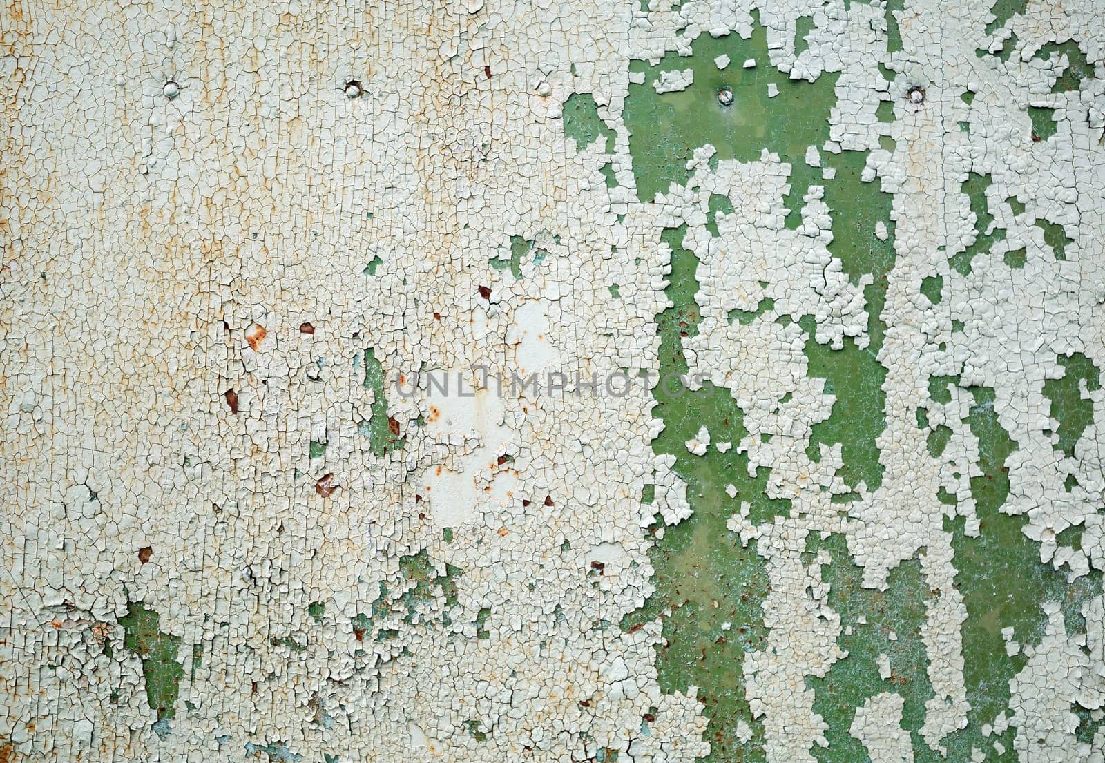 Abstract grunge background. Peeling green paint. Weathered peeling paint texture.